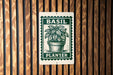 A green and white sign with the word "BASIL" and "PLANTER" printed on it, mounted on a wooden wall.