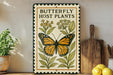 A decorative metal sign with a butterfly and host plant illustration, placed on a wooden surface next to a wooden cutting board and a potted plant.