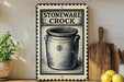 a vintage-style sign for a "Stoneware Crock" with a black and white illustration of a crock pot. The sign is displayed on a shelf next to a wooden cutting board and a potted plant.