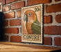 A vintage-style postage stamp featuring a colorful parrot is displayed on a brick wall.
