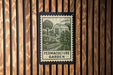 A poster or sign for the "Permaculture Garden" is displayed on a wooden wall.