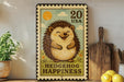 A vintage-style metal stamp depicting a smiling hedgehog, with the text "HEDGEHOG HAPPINESS" and the number "20 USA" printed on it. The stamp is displayed on a shelf next to a wooden cutting board and a potted plant.