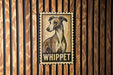 A vintage-style stamp featuring a dog's portrait, with the word "WHIPPET" prominently displayed below the image.