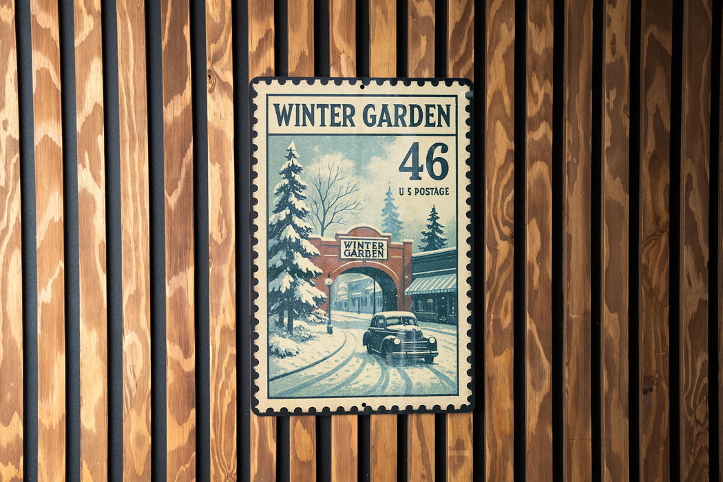A vintage-style postage stamp depicting a snowy winter scene with a car and a building, mounted on a wooden wall.