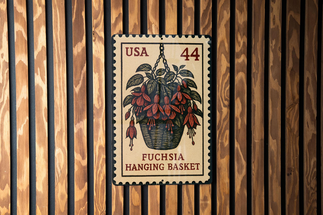 A U.S. postage stamp featuring a hanging basket of fuchsia flowers, mounted on a wooden wall.