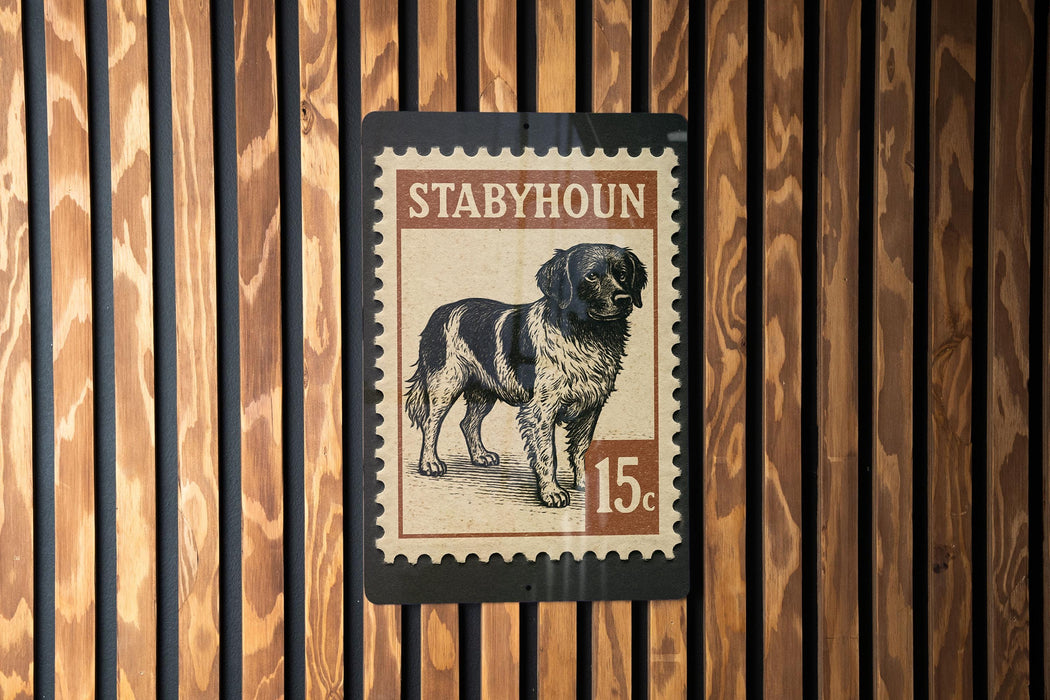 A stamp-like sign featuring a dog illustration and the text "STABHOUN" and "15c" printed on it, mounted on a wooden wall.