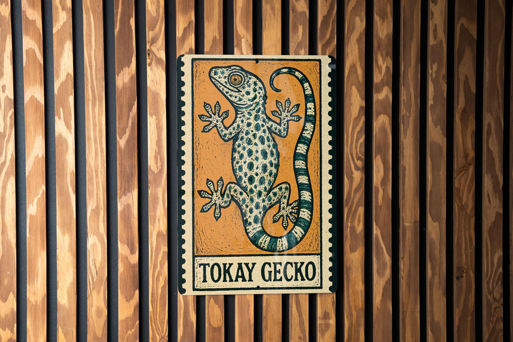 A sign featuring a gecko, with the text "Tokay Gecko" below the illustration.