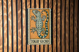 A sign featuring a gecko, with the text "Tokay Gecko" below the illustration.