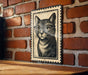A black and white illustration of a cat wearing glasses is displayed on a brick wall.