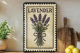 A framed illustration of lavender flowers is displayed on a shelf, accompanied by kitchen utensils and a potted plant.