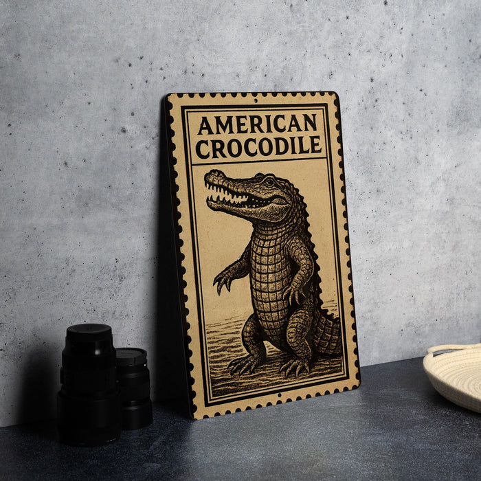 a wooden sign with an illustration of an American crocodile, placed on a table next to some black camera lenses.