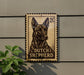 A metal sign featuring a dog's head and the text "DUTCH SHEPHERD" is mounted on a wall.