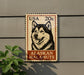 A metal sign featuring a black and white illustration of a husky dog, with the text "USA 20c ALASKAN MALAMUTE" printed on it.