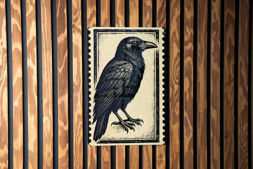 a black and white illustration of a bird, specifically a crow, mounted on a wooden wall.