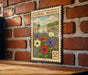 a vintage-style metal stamp with a floral illustration on a brick wall.