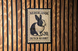 A postage stamp featuring a Dutch rabbit, with the text "Nederlande 20, Dutch rabbit" printed on it.