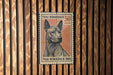 A Thai Ridgeback dog is depicted on a Thai postage stamp, which is affixed to a wooden wall.