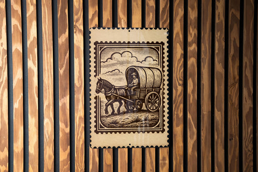A wooden wall with a framed image depicting a person riding a horse-drawn carriage.