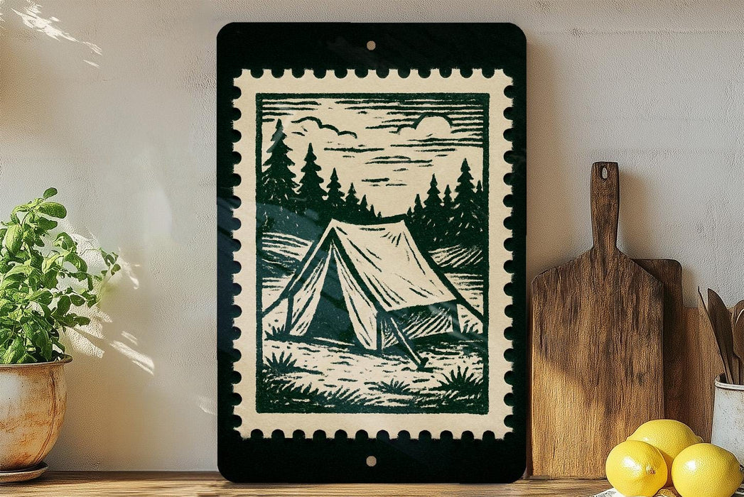 a framed illustration of a tent set up in a forest, surrounded by pine trees and a cloudy sky, placed on a shelf next to a wooden cutting board and a potted plant.