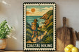 A vintage-style metal sign with a hiker on a trail, surrounded by a coastal landscape, is displayed on a shelf with a potted plant and a wooden cutting board nearby.