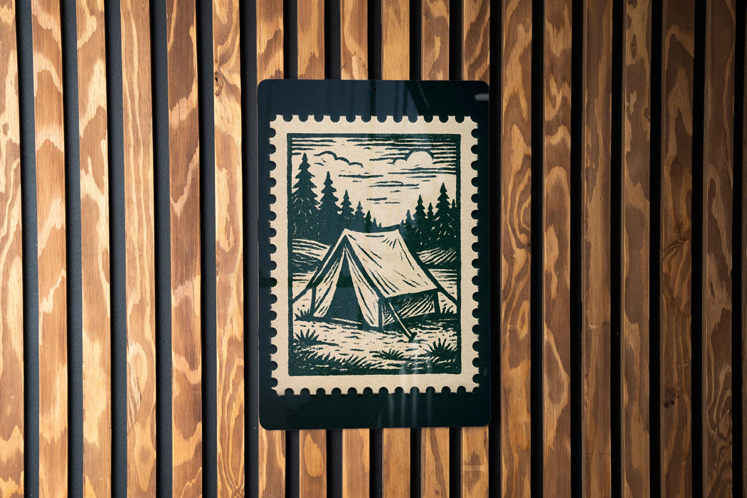 A black and white illustration of a tent is displayed on a wooden wall, with a black border around it.