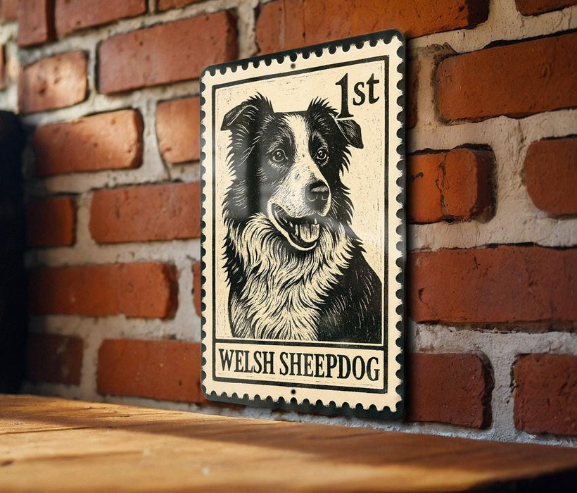 A metal sign featuring a black and white illustration of a Welsh sheepdog, mounted on a brick wall.