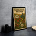 A framed illustration of a wildflower meadow, featuring various colorful flowers and plants, is displayed on a wall.