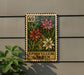 A decorative metal plaque with a floral design, mounted on a wall next to a plant.