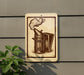 a sign with a drawing of a metal container, possibly a teapot or a smoking device, mounted on a wall.