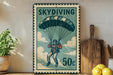 A vintage-style metal sign with a parachute and the number "50c" printed on it, placed on a wooden surface next to a potted plant and a wooden cutting board.
