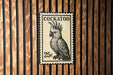 A black and white postage stamp featuring a cockatoo, with the text "COCKATOO" and the value "25c" printed on it.