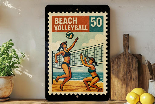 A framed vintage-style poster of two women playing beach volleyball, with a beach volleyball depicted in the center of the frame.