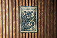 A vintage-style postage stamp featuring a sugar glider, with the text "SUGAR GLIDER" and the denomination "25¢".