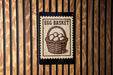 a sign with the text "Egg Basket" and an illustration of a basket filled with eggs.