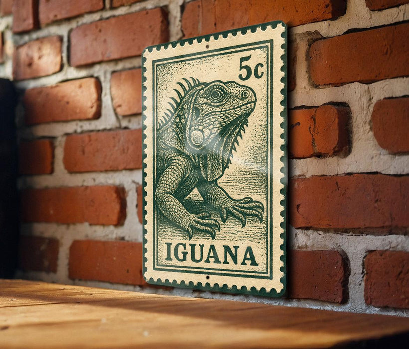 A green and white postage stamp featuring an illustration of an iguana is displayed on a brick wall.