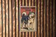 A poster of a husky dog is displayed on a wooden wall.