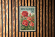 A vintage rose garden postage stamp is displayed on a wooden wall.