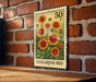 A 50 cent postage stamp from Gaillardia Bed is displayed on a brick wall, featuring a vibrant illustration of the flower.