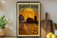 A framed stamp depicting a farm scene with a large full moon, a barn, and a field of crops, along with the text "Harvest Moon" and "USA 25".