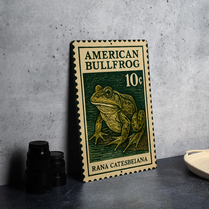 A metal stamp featuring an illustration of a bullfrog, with the text "AMERICAN BULLFROG 10¢" printed on it.