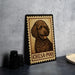 A framed illustration of a poodle dog, labeled "CHESA-POO", is displayed on a table next to a stack of black camera lenses.