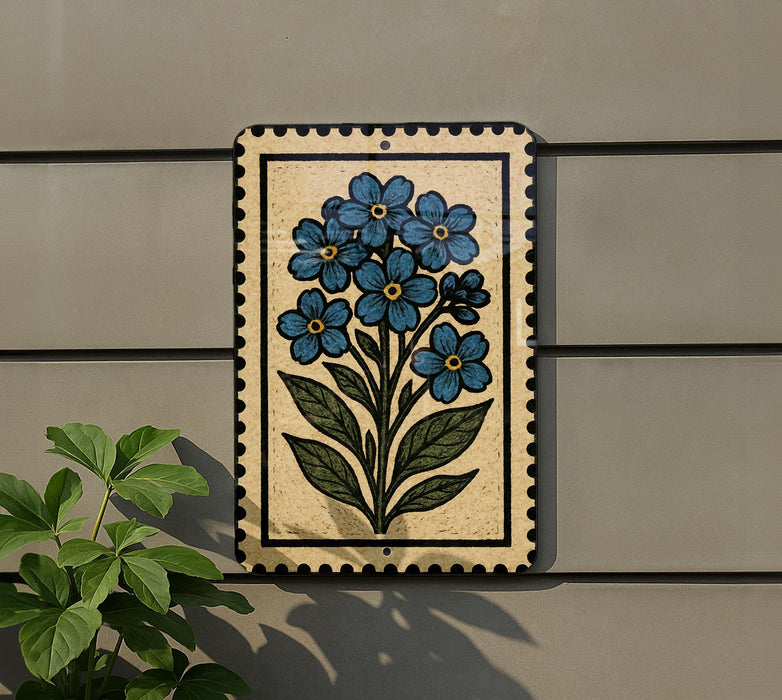 A decorative tile with a blue flower design is mounted on a wall, accompanied by a small green plant to the left.