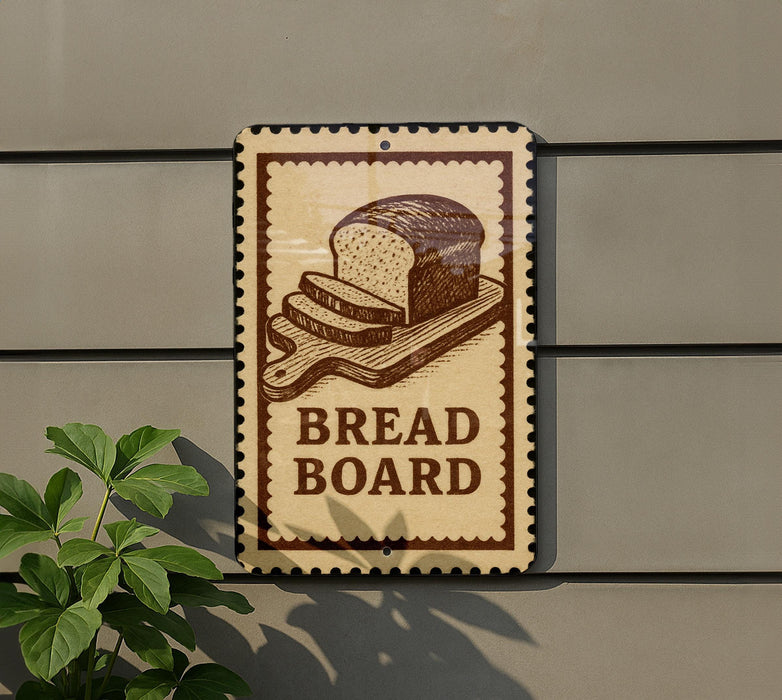 A sign that reads "BREAD BOARD" is mounted on a wall, with a plant visible to the left of the sign.