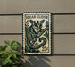 A metal sign with a sugar glider illustration and the price of 25 cents displayed on a wall.