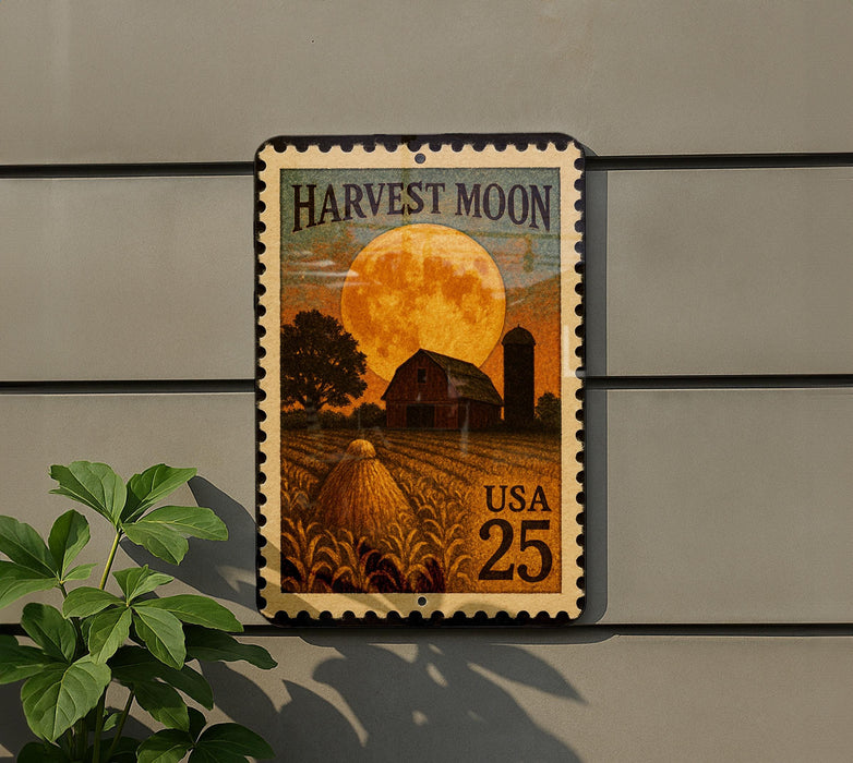 A metal sign with a large stamp depicting a farm scene with a full moon and a barn, mounted on a wall.
