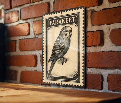 A vintage-style postage stamp featuring a parakeet is displayed on a brick wall.