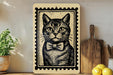 a framed illustration of a cat wearing a bow tie, placed on a shelf next to a wooden cutting board and some lemons.