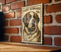 A wooden table with a framed image of a Saint Bernard dog, which appears to be a postage stamp.
