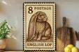 A vintage-style 8 postage stamp featuring an illustration of an English lop rabbit, placed on a wooden surface next to a wooden cutting board and some lemons.