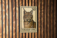 A postage stamp featuring an illustration of a European lynx, a wild cat native to Europe and Asia.